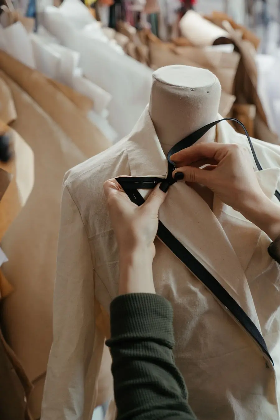 Hands fitting and marking a toile