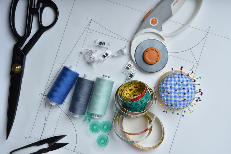 Sketches and cutting tools laid out on a table
