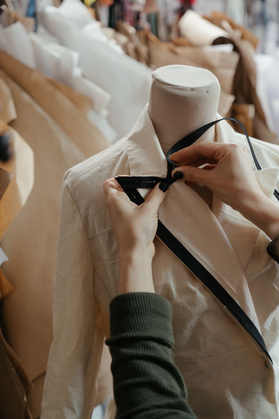 Hands fitting and marking a toile